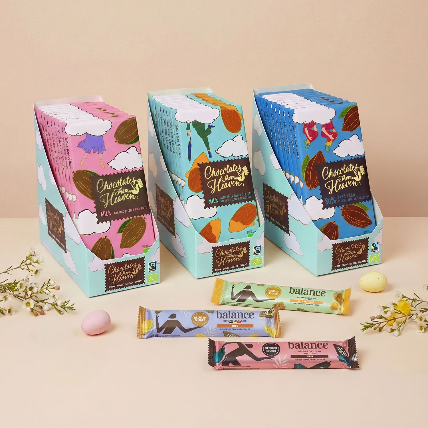 Drie displaydozen met Chocolates from Heaven fairtrade chocoladerepen en suikerarme Balance repen, gepresenteerd als beter paasgeschenk voor personeel.